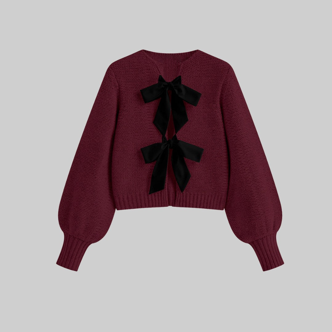 Stickad kofta med satinrosetter och ballongärmar