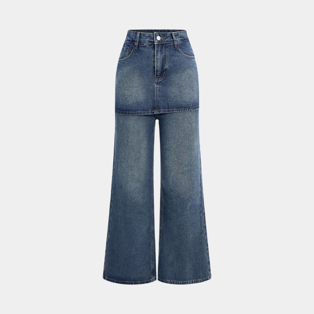 Mörkblå denimbyxa med markerad midja, kjol-liknande överdel och utställda ben