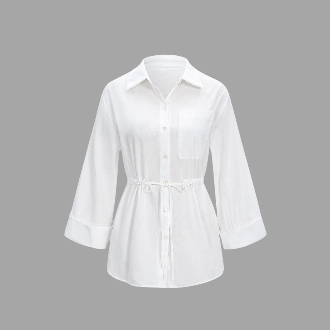 Vit skjortblus i bomull med midjedragning och breda manschetter