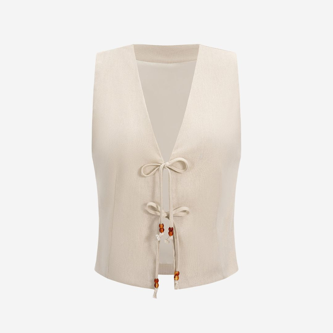 Beige ärmlös väst i vävd struktur med dekorativa snören och pärldetaljer