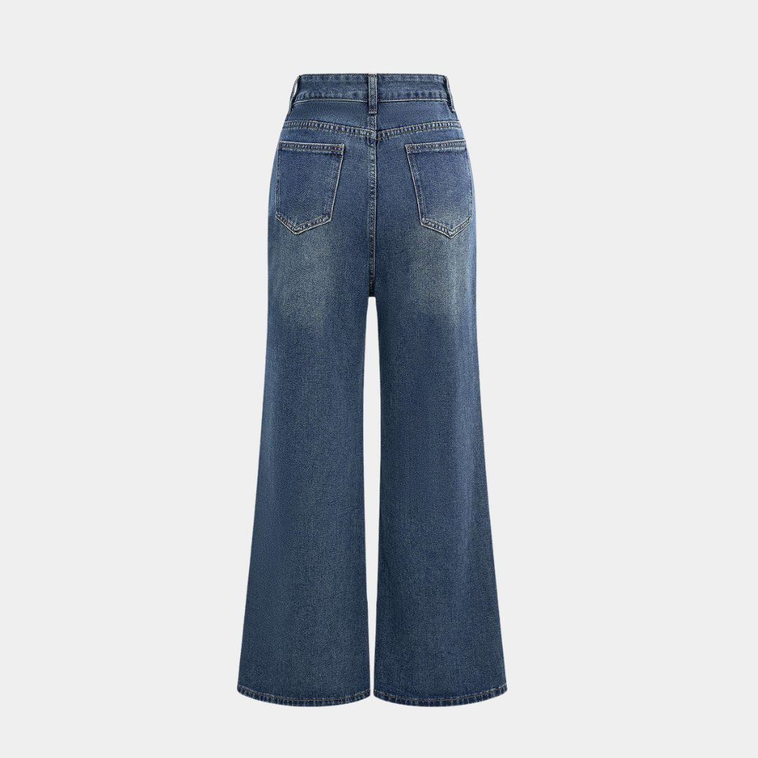 Mörkblå denimbyxa med markerad midja, kjol-liknande överdel och utställda ben