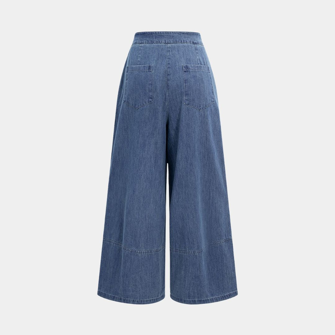 Blå omlottinspirerade denimbyxor med knytband i midjan, vida ben och sömdetaljer över knäna