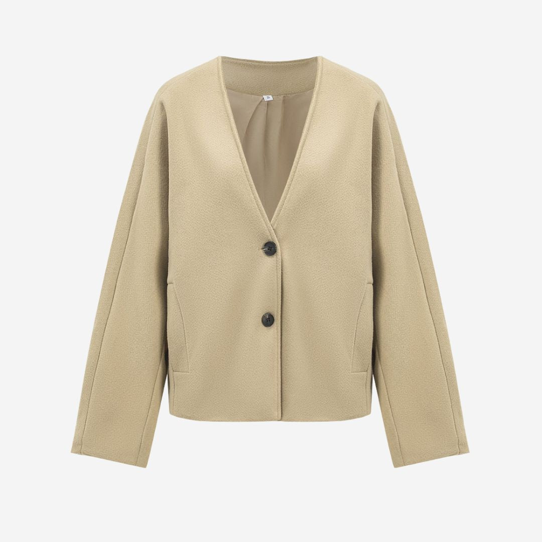 Beige kort jacka i strukturerad tygblandning med v-ringning och knappar framtill