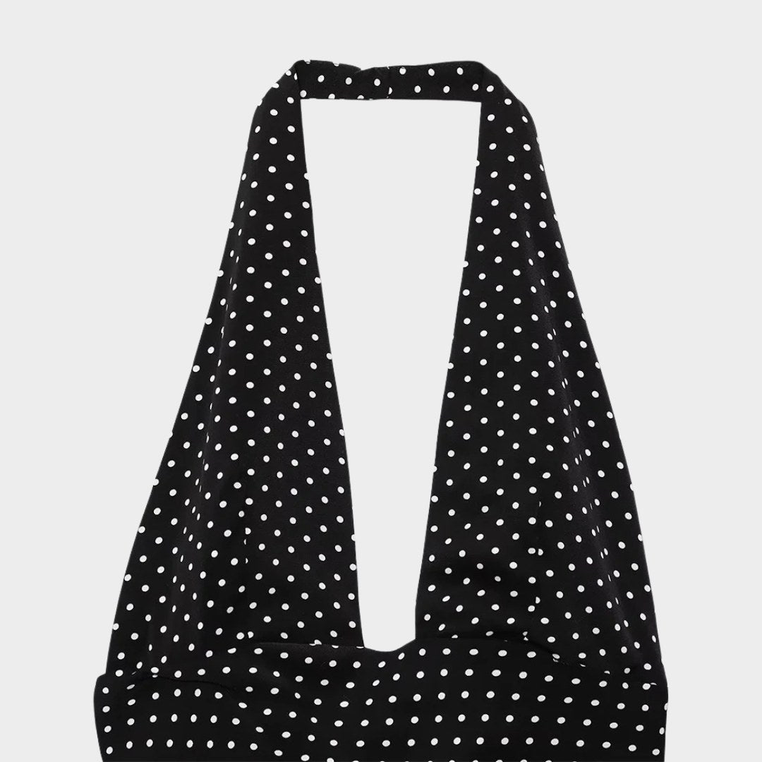 Svart halterneck-klänning med prickigt mönster och öppen rygg