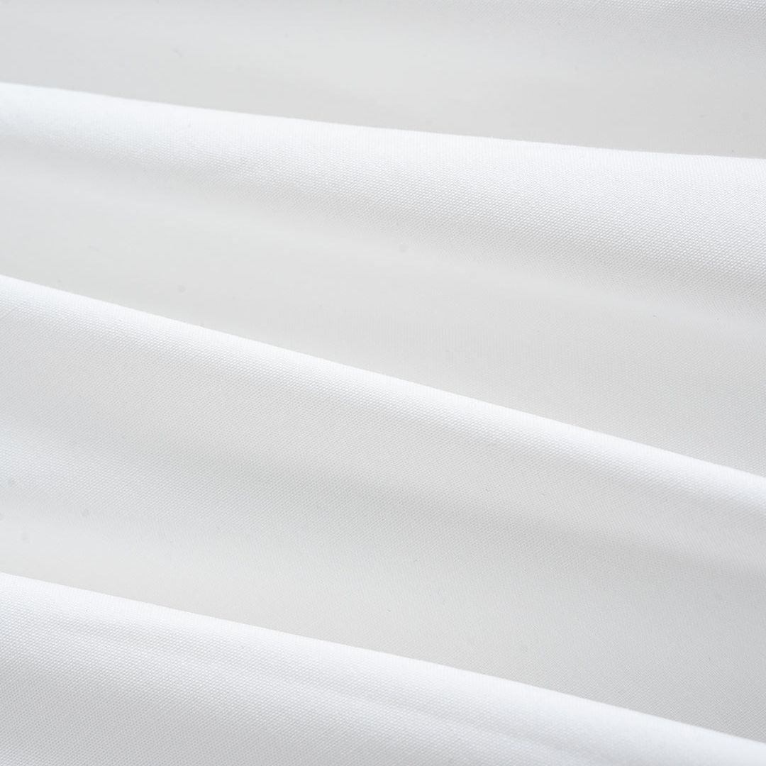 Vit blus med voluminösa draperade ärmar och pärlknappar