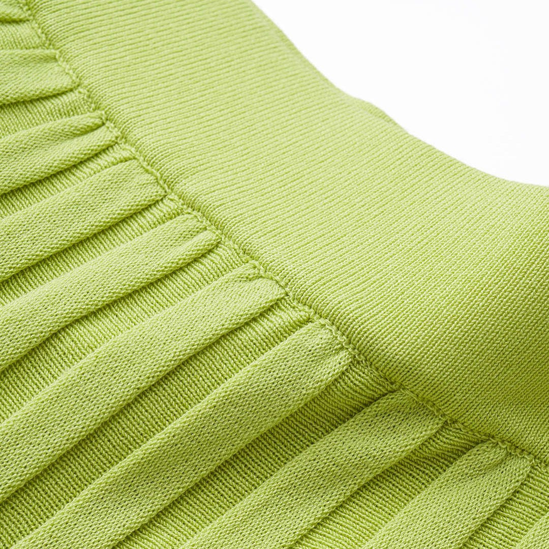 Grön plisserad midikjol i stickad bomullsblandning med lös passform och mellanstretch