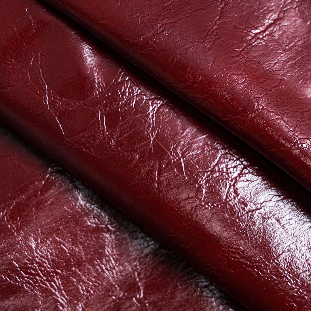 Vinröd topp i veganskt läder med asymmetrisk axel och figurnära passform