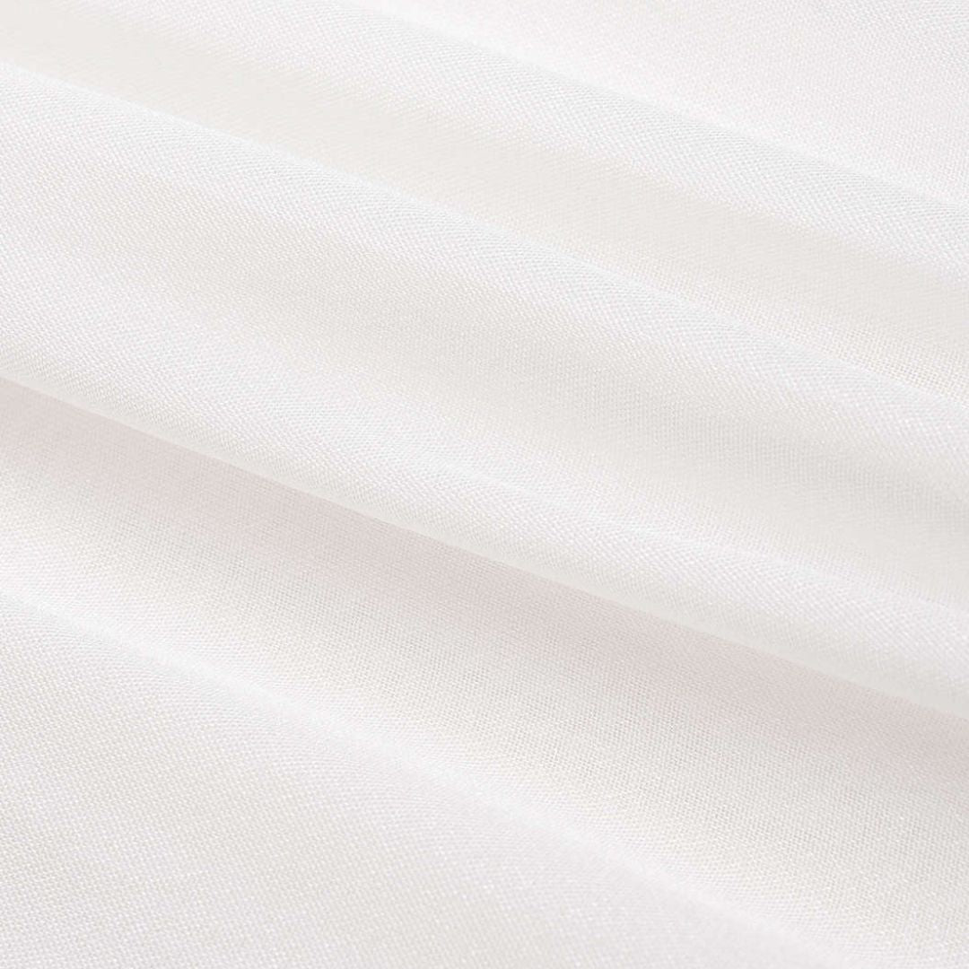 Vit kort organzatopp med transparenta ärmar och metallknappar vid manschetterna