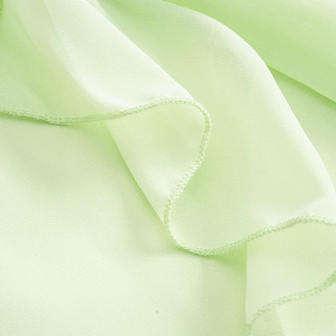 Ljusgrön chiffontunika med volangärmar och rynkad halsringning