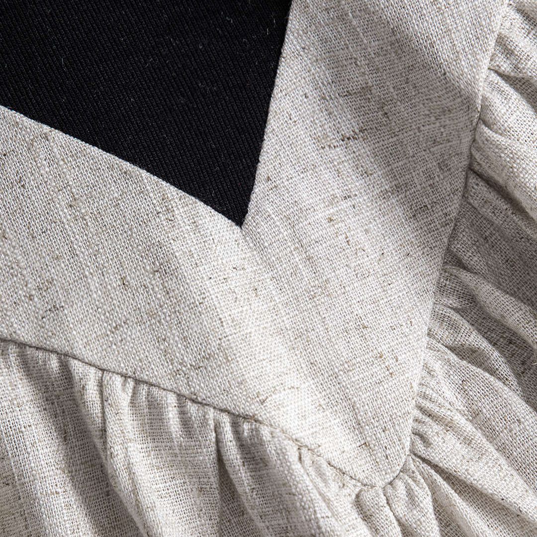 Svart tvåfärgad klänning med linnelook och figurnära överdel