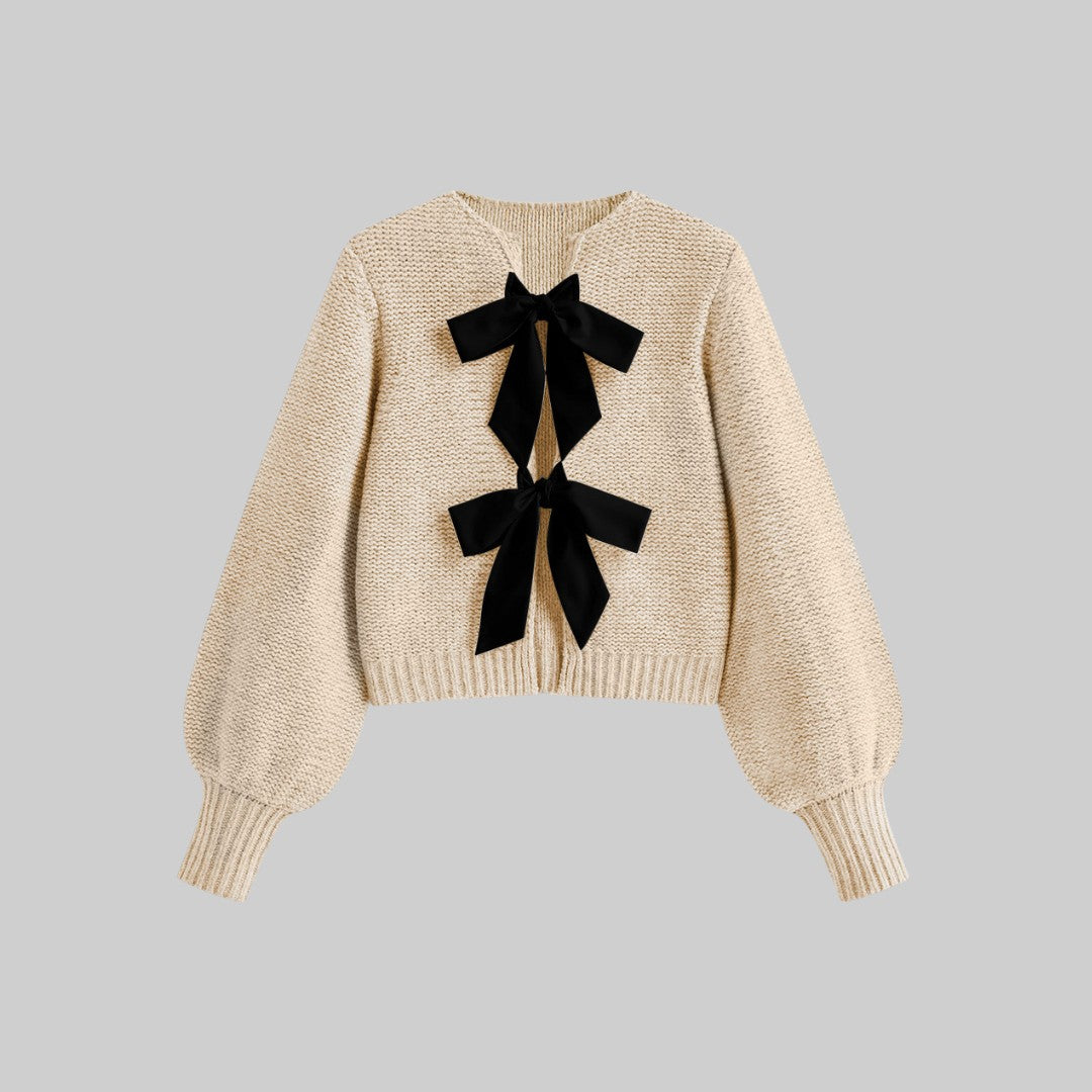 Stickad kofta med satinrosetter och ballongärmar