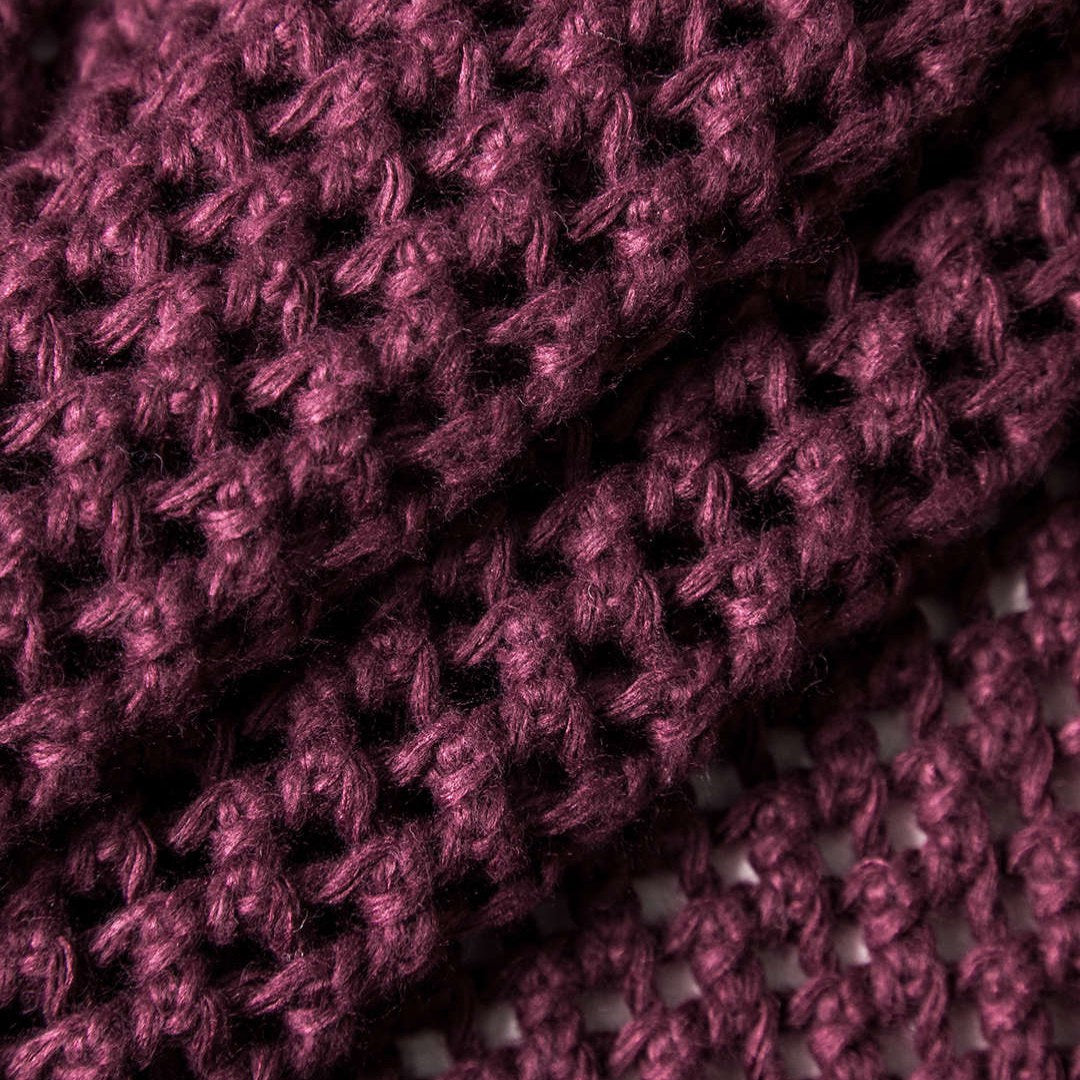 Stickad kofta i virkad struktur med fickor och stora dekorativa knappar