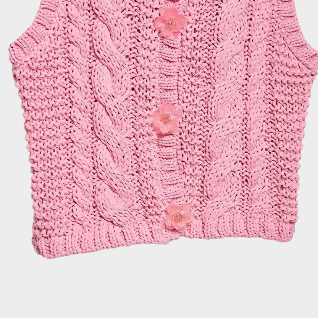 Rosa kabelstickad kofta utan ärmar med blomknappar