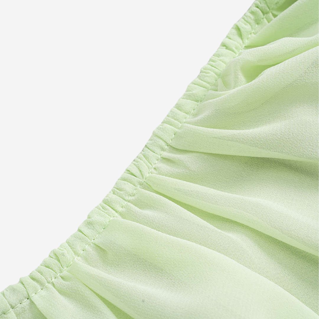 Ljusgrön chiffontunika med volangärmar och rynkad halsringning