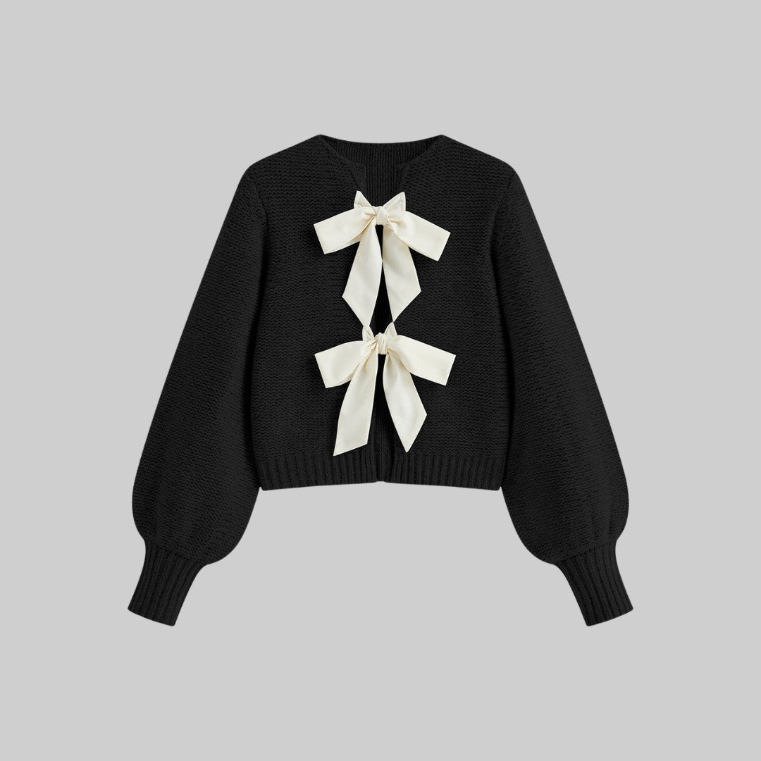 Stickad kofta med satinrosetter och ballongärmar