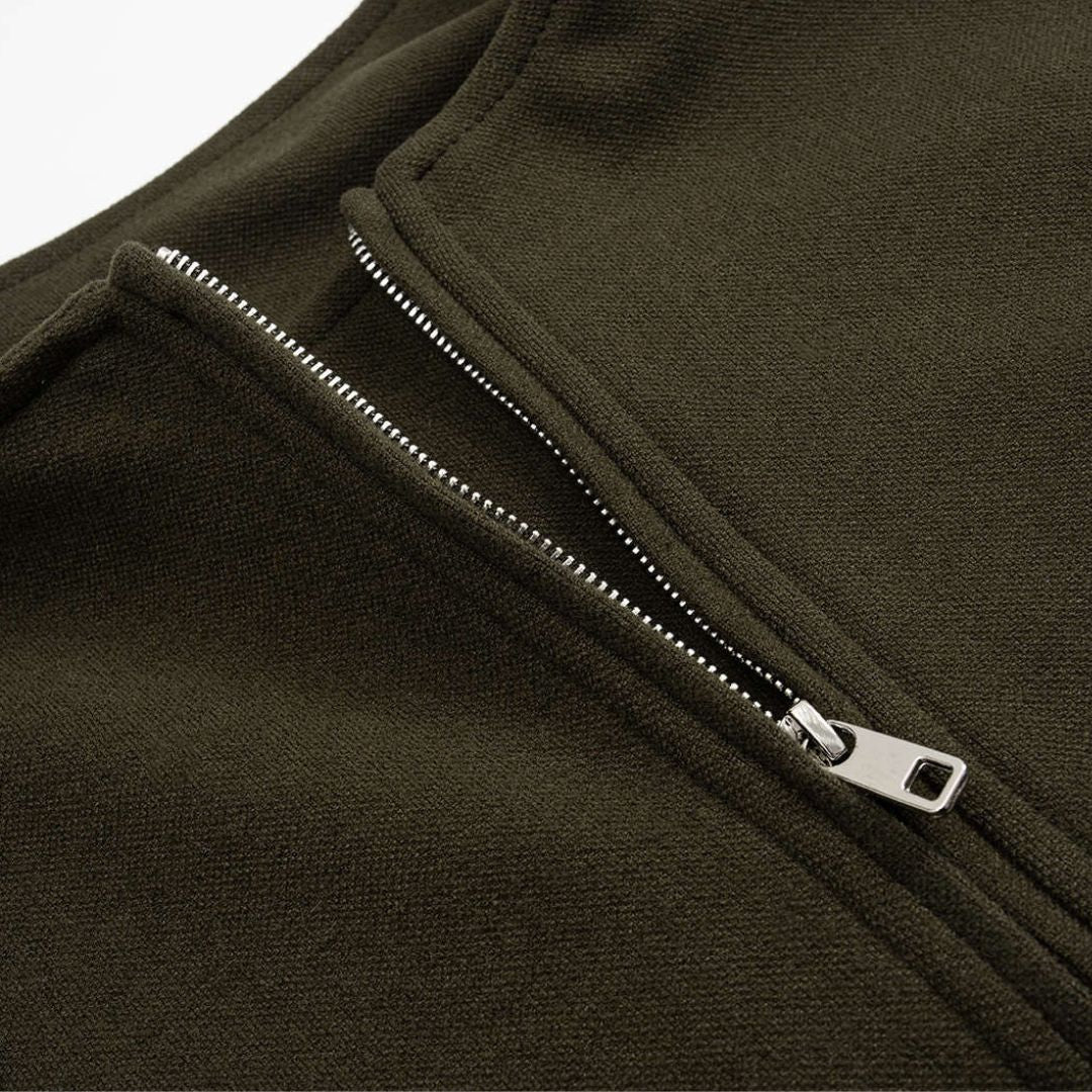 Mörkgrön ärmlös jackväst i strukturerat tyg med dragkedja och ficklock för dam