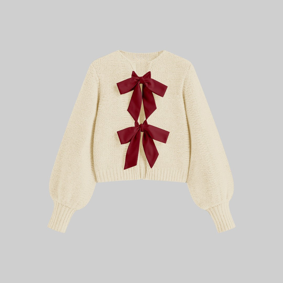 Stickad kofta med satinrosetter och ballongärmar