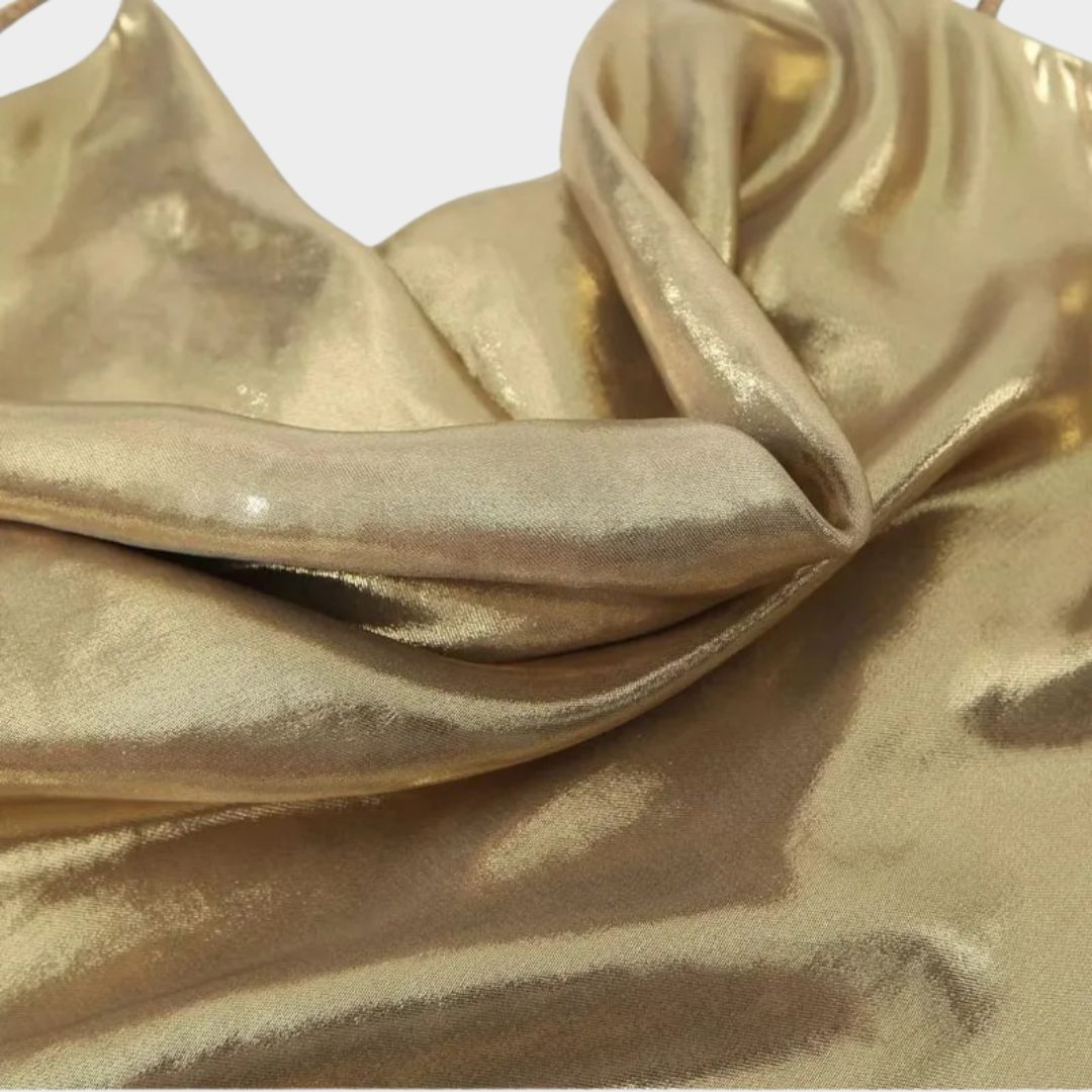 Glittrande miniklänning med smala axelband och öppen rygg