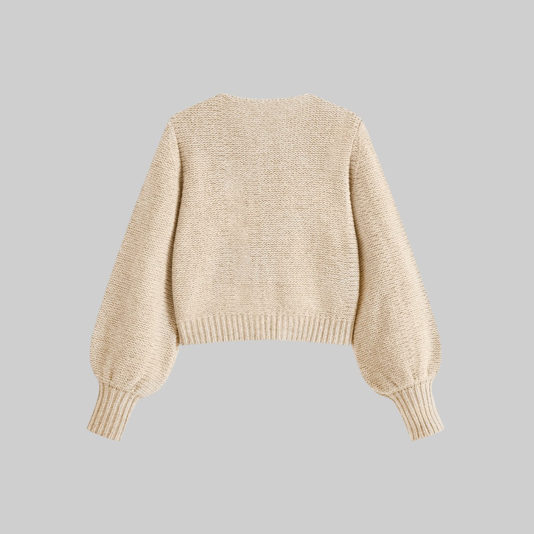 Stickad kofta med satinrosetter och ballongärmar