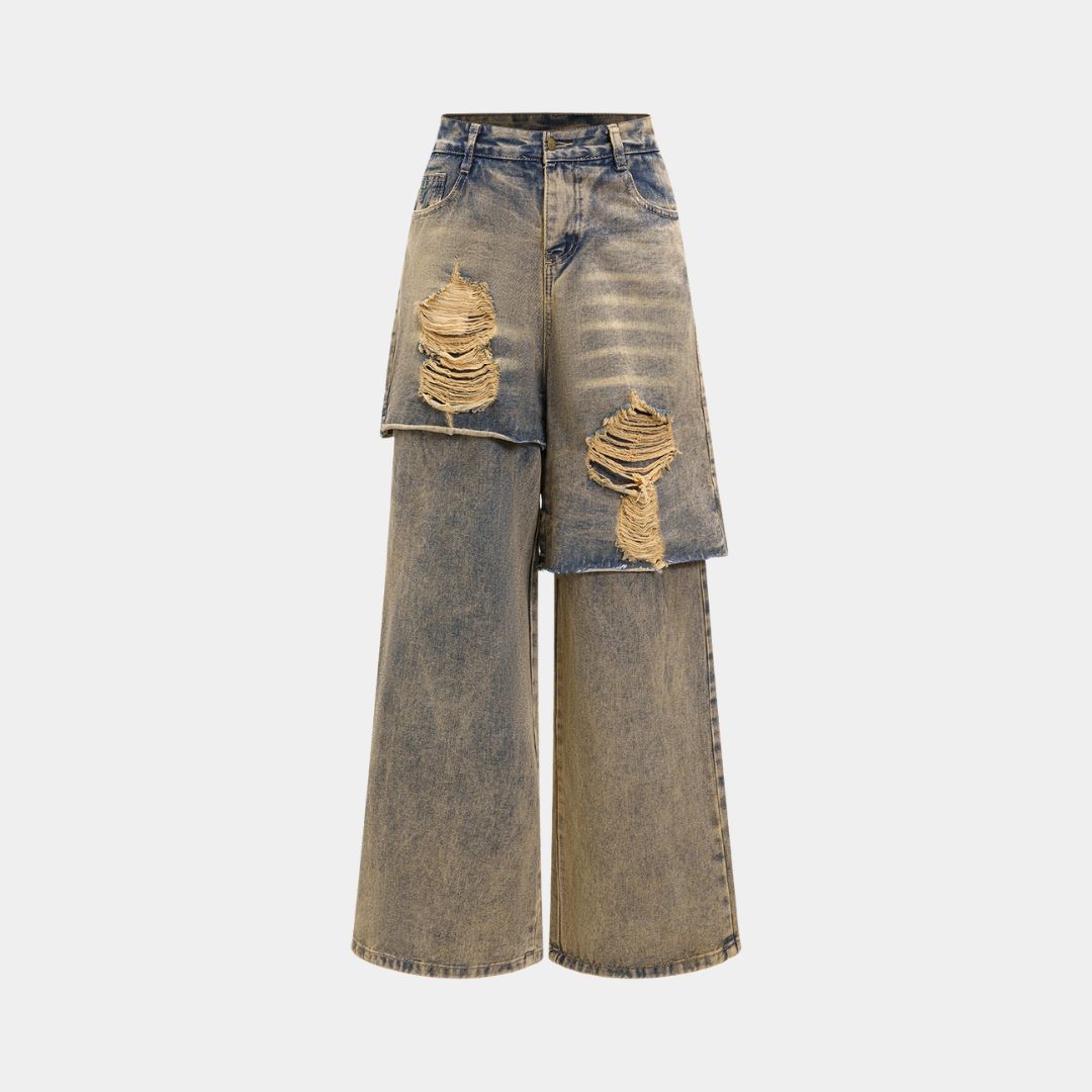 Distressed denimjeans med asymmetriskt shortsöverlägg, rå tvätt och överdrivna slitningar i kraftig bomullsblandning