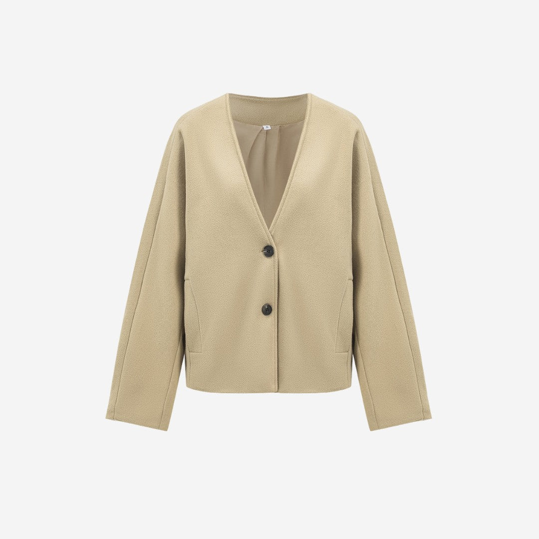 Beige stickad kavaj med djup V-ringning och knappar framtill