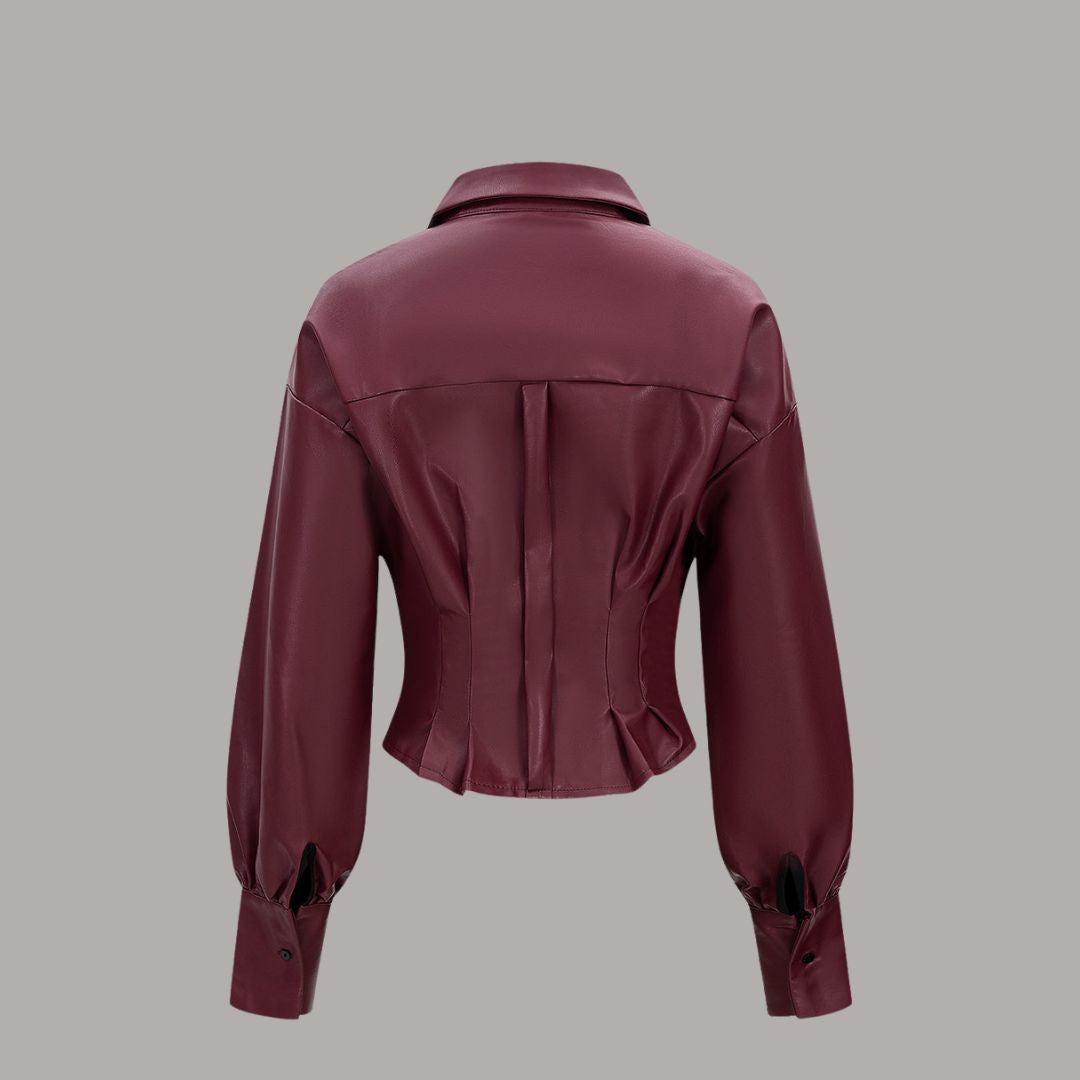 Vinröd blus i konstläder med markerad midja och bredt bälte