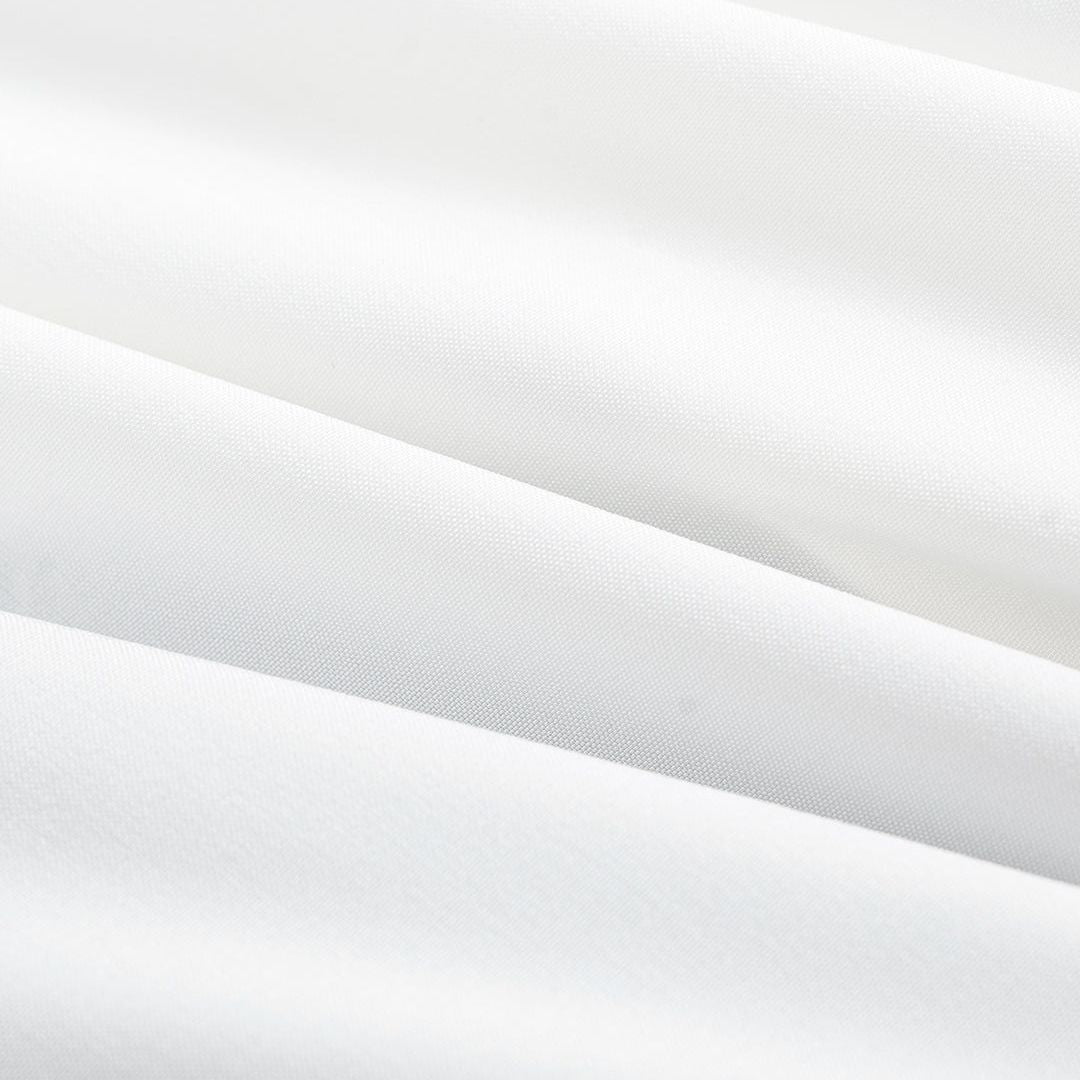 Svartvit asymmetrisk skjorttopp med draperad front och dekorativa guldknappar