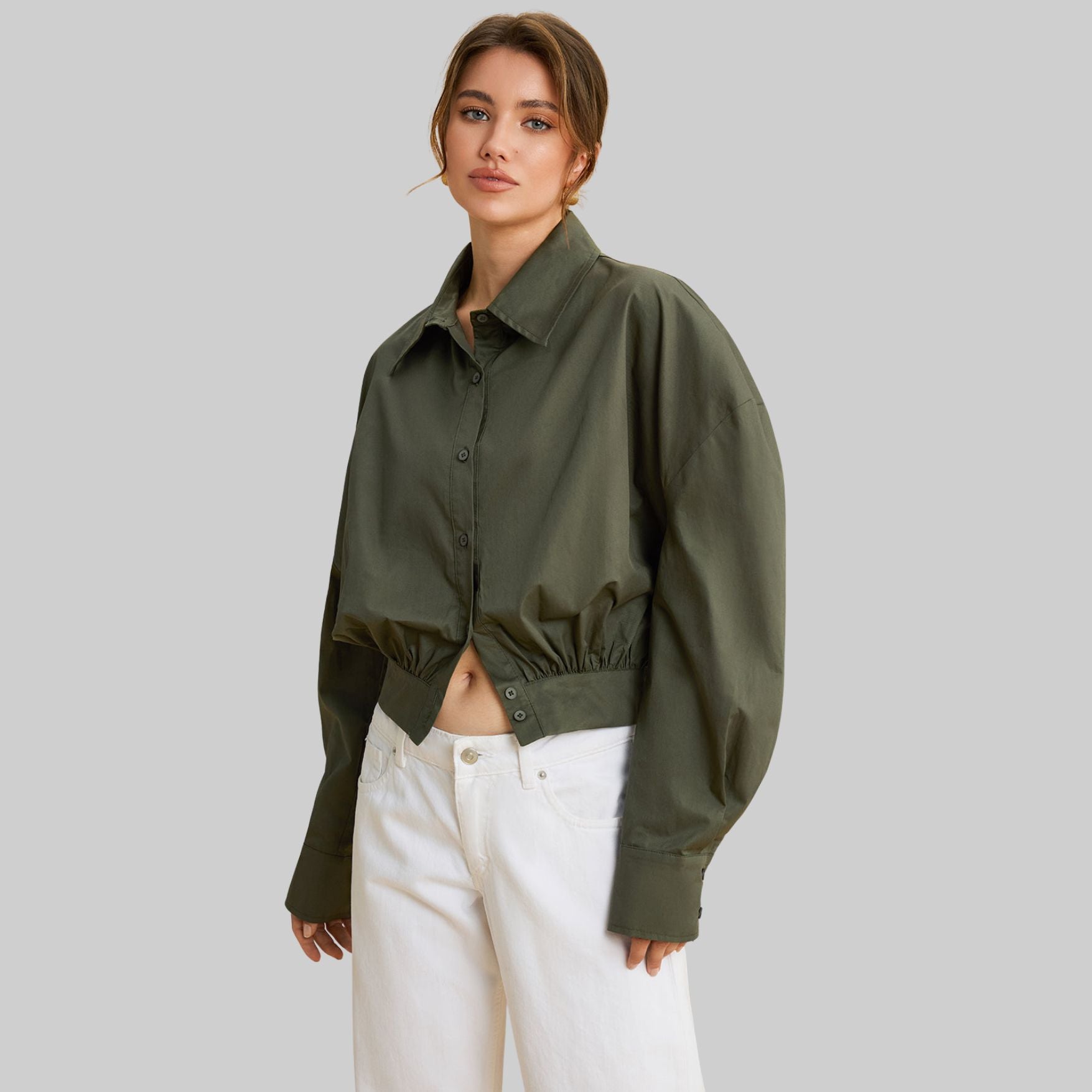 Mörkgrön långärmad topp i vävd polyesterblandning med figurnära passform och slät yta