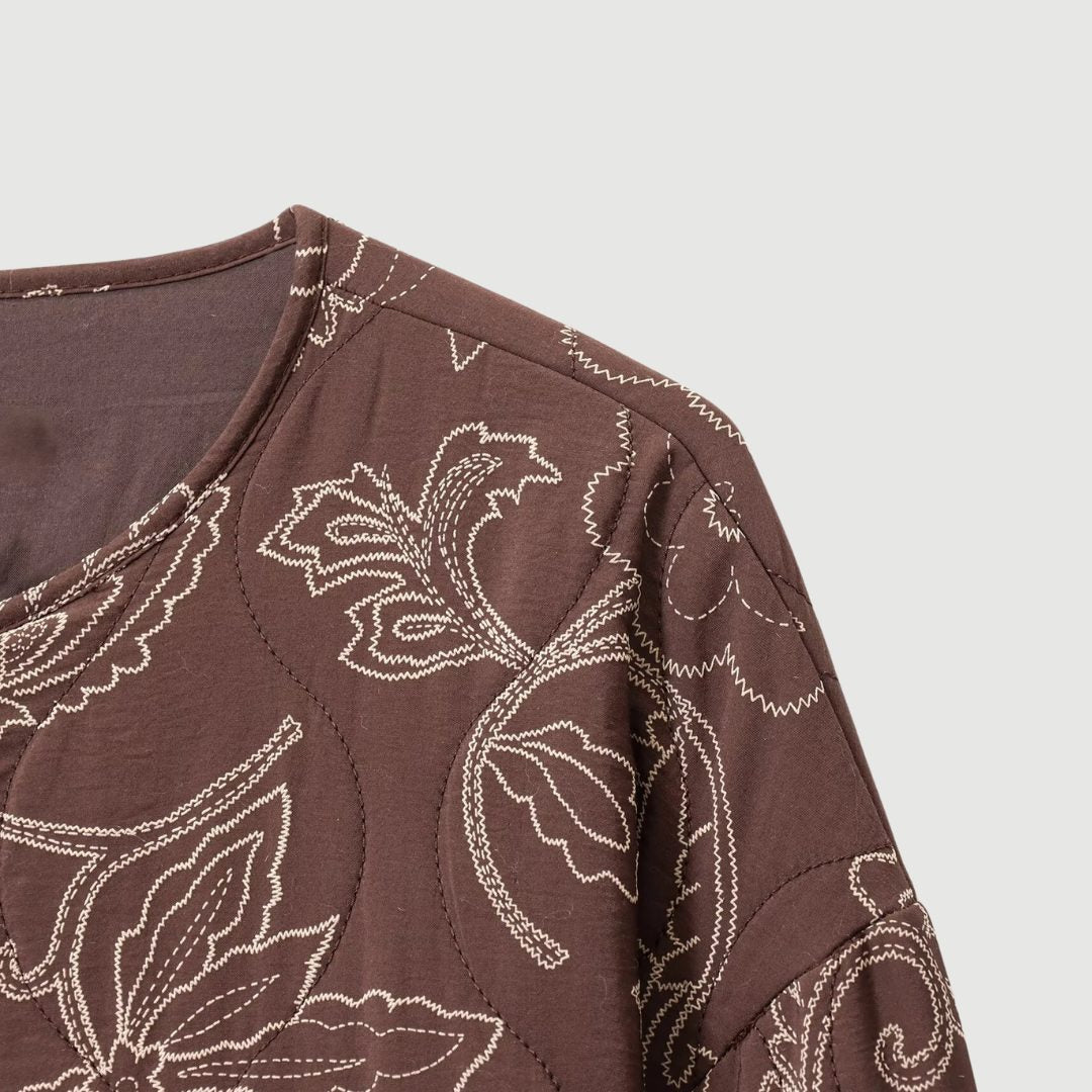 Kort blommönstrad vadderad jacka med broderi och rund hals
