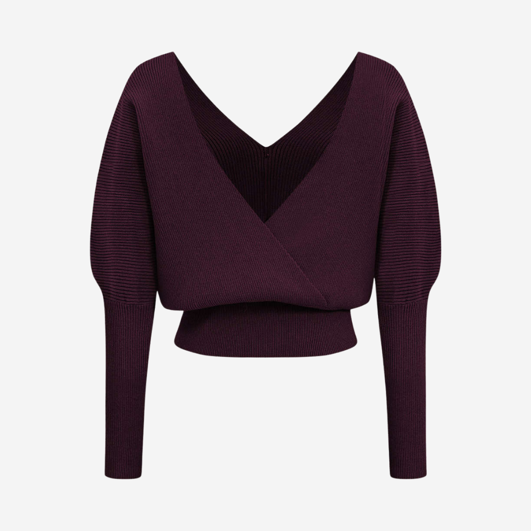 Stickad topp med dekorativa knappar och djup urringning för elegant vardagsstil