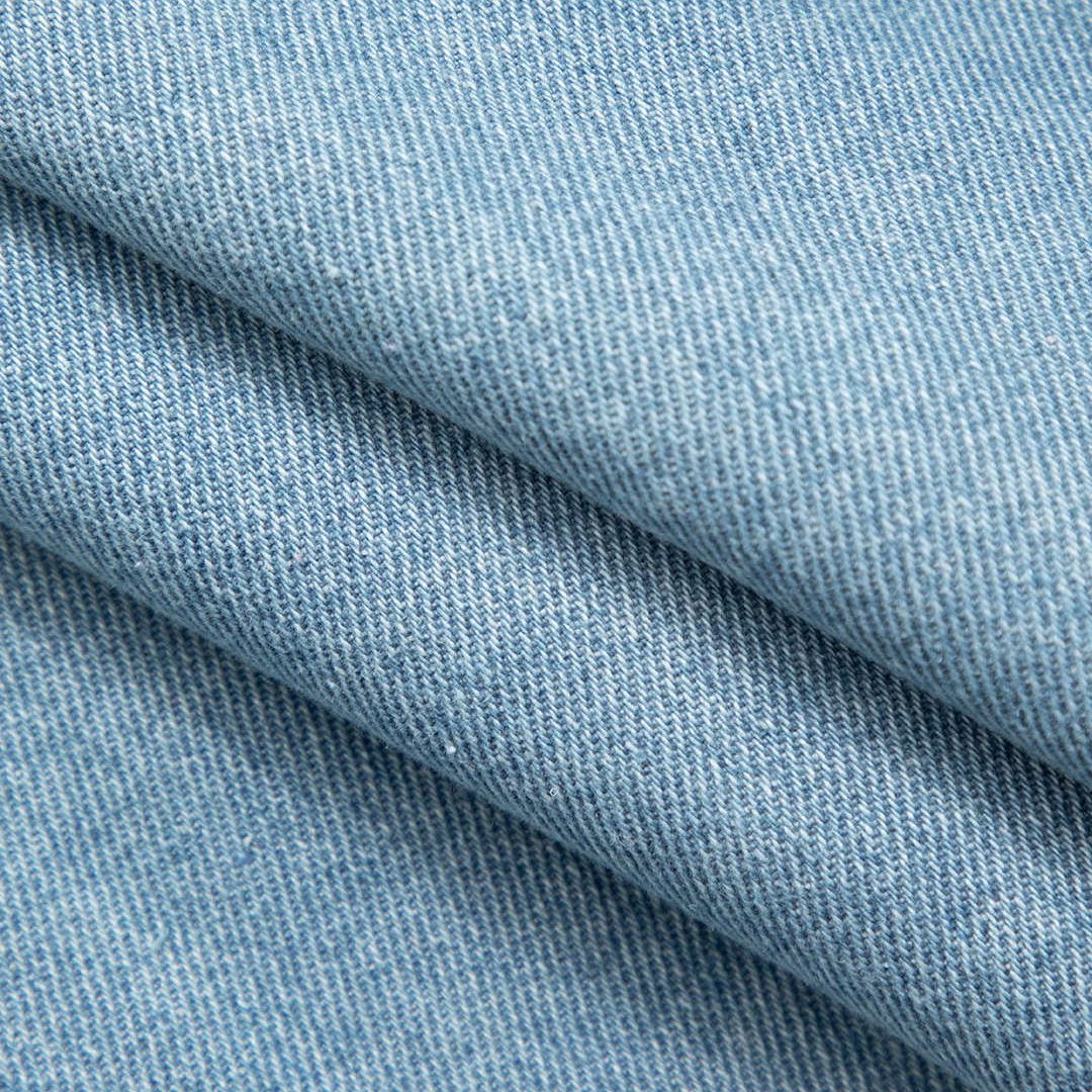 Extra kort ärmlös jeansväst med bröstfickor och tryckknappar i klassisk denim